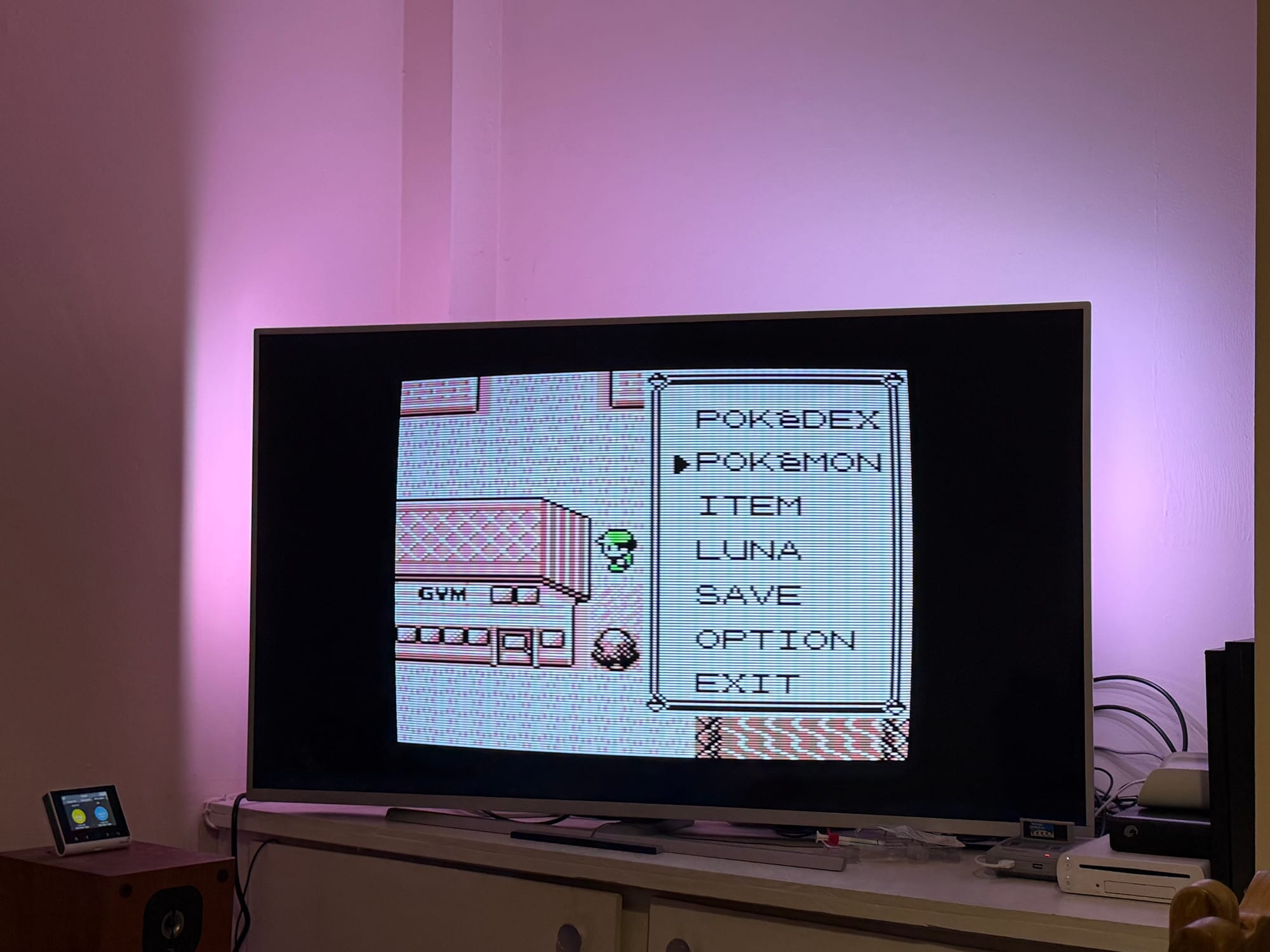 Pokemon Red on a large TV with ambient light being shown. The pokemon game has a CRT effect applied