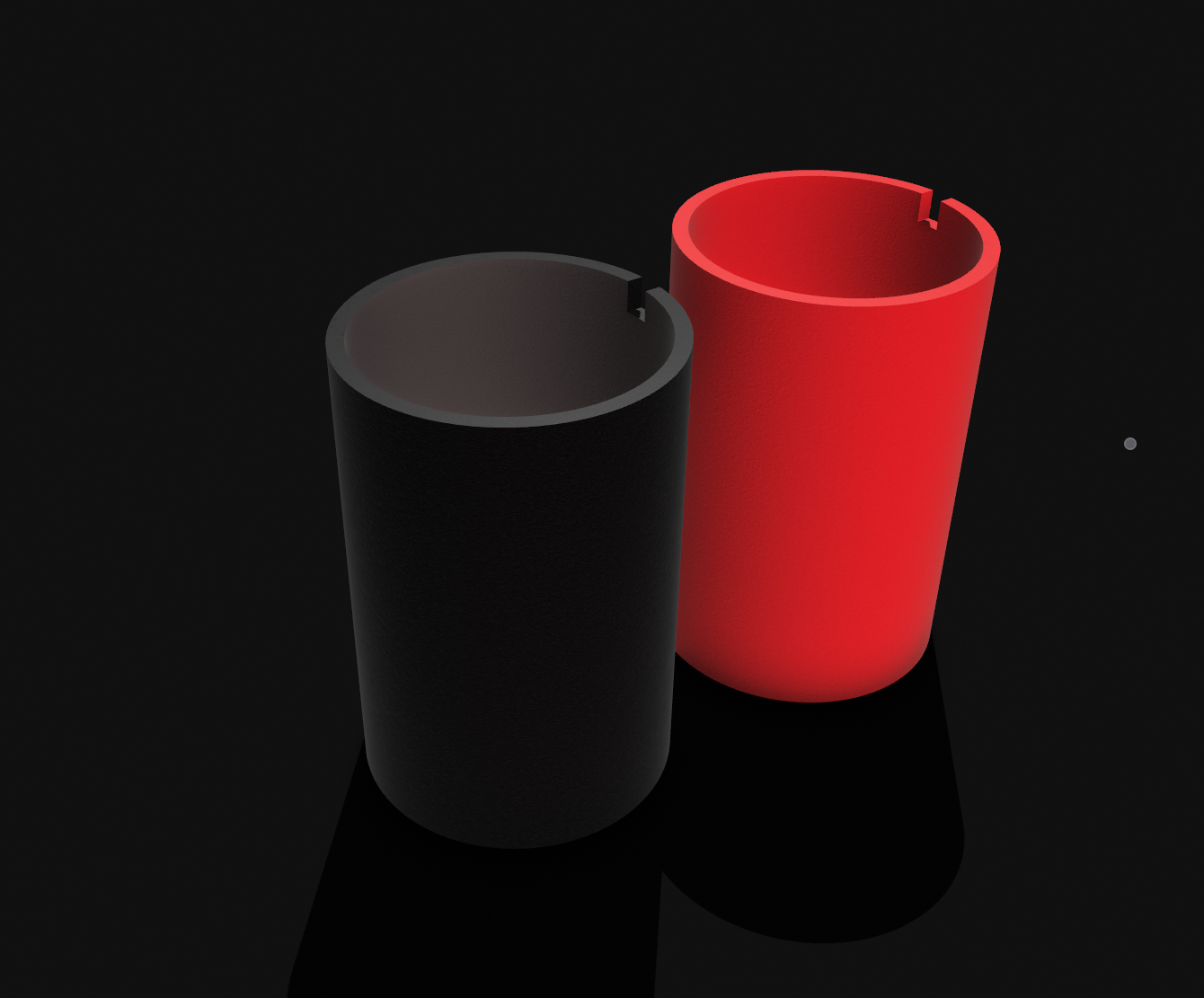 Two cylinders rendered in black and red respectively, they have a notch cut out of them